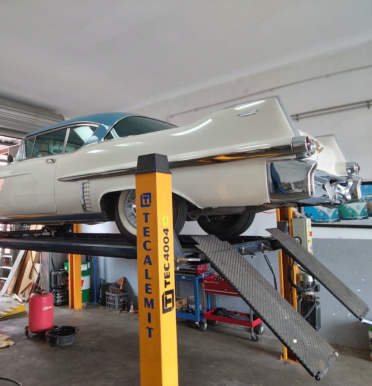 Classic vehicle raised on a workshop lift